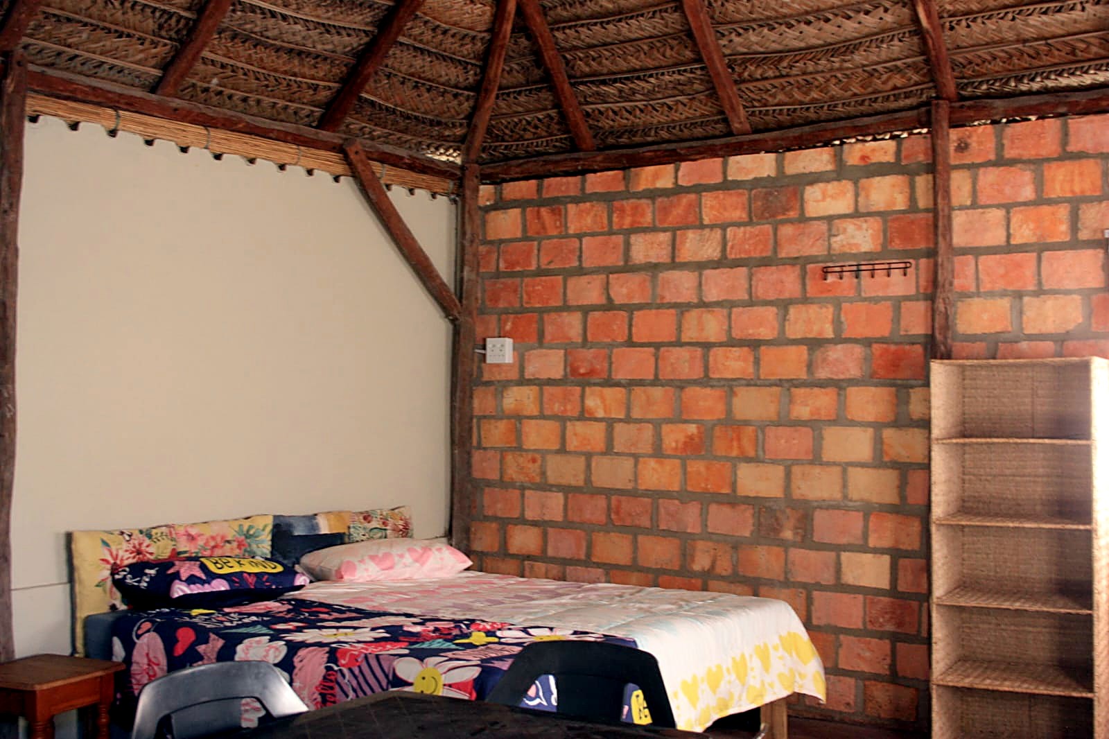 The bed under a mosquito net in the Cottage
