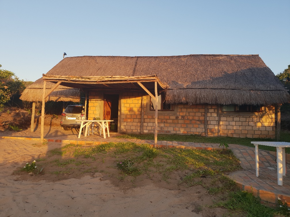The House at Terra Bella, with shaded parking under the thatch